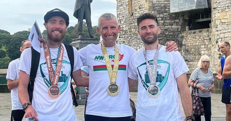Regional Half Marathon Championships Within the Caernarfon Race, 10.9.2023. Photo by Scot Nixon, Centre: Winner and 1st M45 Martin Green, left Scott Nixon 1st Senior Man, right 1st M35 Llyr Gruffydd