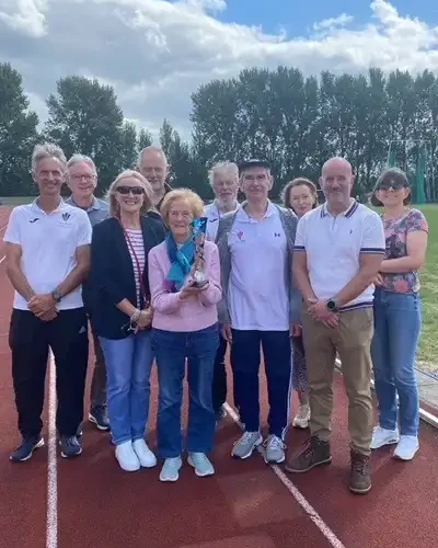 The family of the late Reg Burke gathered at the Queensway Stadium in Wrexham on 2nd August, to receive a trophy awarded after his posthumous induction into the North Wales Regional Athletics Council’s Hall of Fame. Pictured are Reg’s wife and family, with Wrexham A.C.’s track and field secretary Mike Robbins (left) and Club Chair Dave Edwards (centre), NWRAC secretary Paul Brooks (centre) and former Wales national coach Geoff Ward (back left) and his daughter (right). Photo: Bernie Jones.